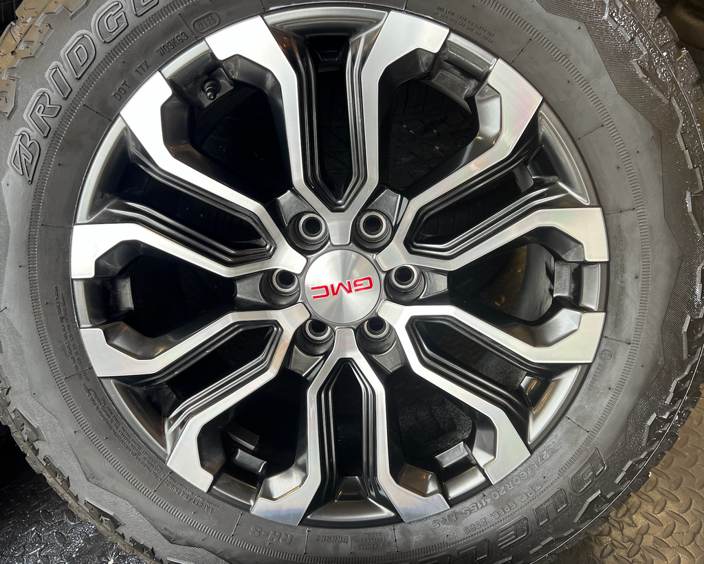 OEM 20” Charcoal Machined Wheels wrapped in Bridgestone Dueler A/T tires.