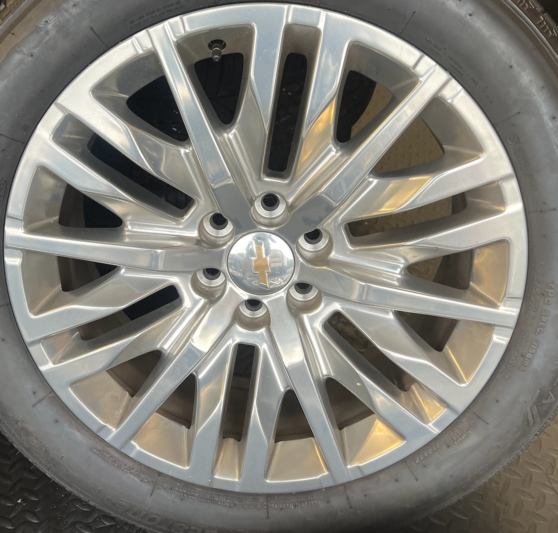 OEM 22” Polished 6-Split-Spoke Chevrolet Wheels wrapped in Bridgestone tires.