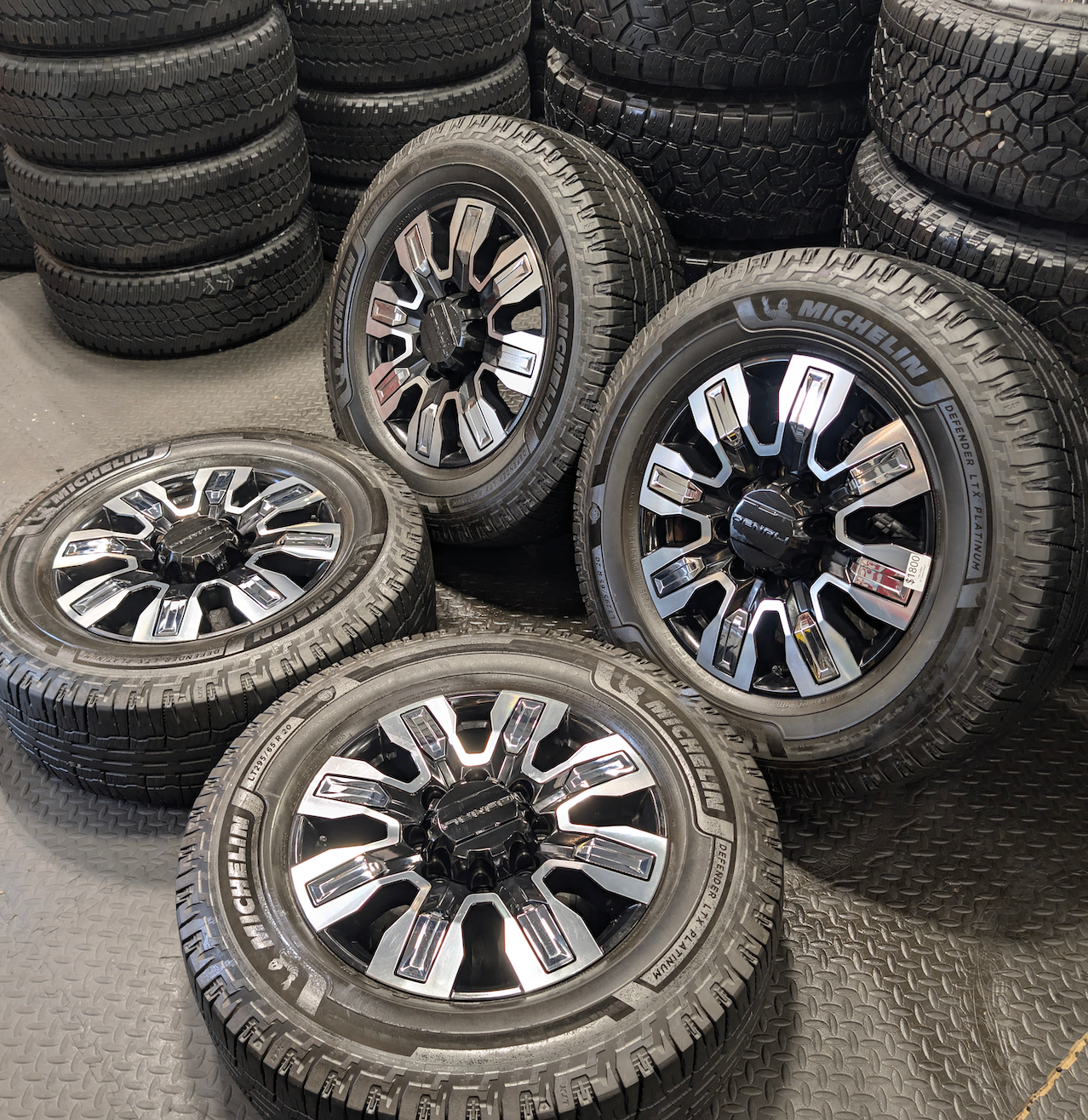 OEM 20” GMC Sierra Denali Ultimate Wheels with Machined & Black Finish wrapped in LT295/65R20 Michelin Defender LTX Platinum tires.