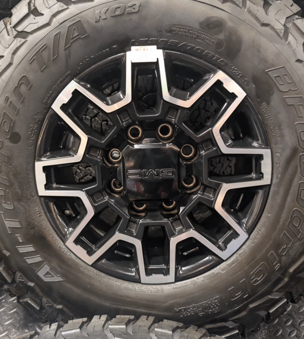 OEM 18” GMC Sierra 2500HD Wheels with Machined Black Finish wrapped in LT305/70R18 BFGoodrich All-Terrain T/A KO3 tires.