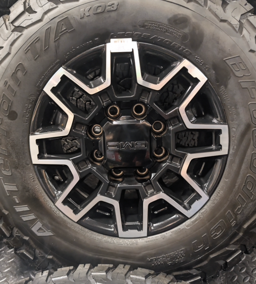 OEM 18” GMC Sierra 2500HD Wheels with Machined Black Finish wrapped in LT305/70R18 BFGoodrich All-Terrain T/A KO3 tires.