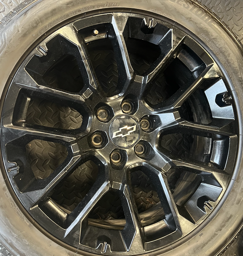 OEM 22” Gloss Black Replica Wheels wrapped in Bridgestone tires.
