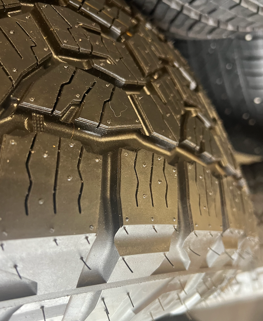 OEM 18” Gloss Black Wheels wrapped in Toyo Open Country A/T tires.