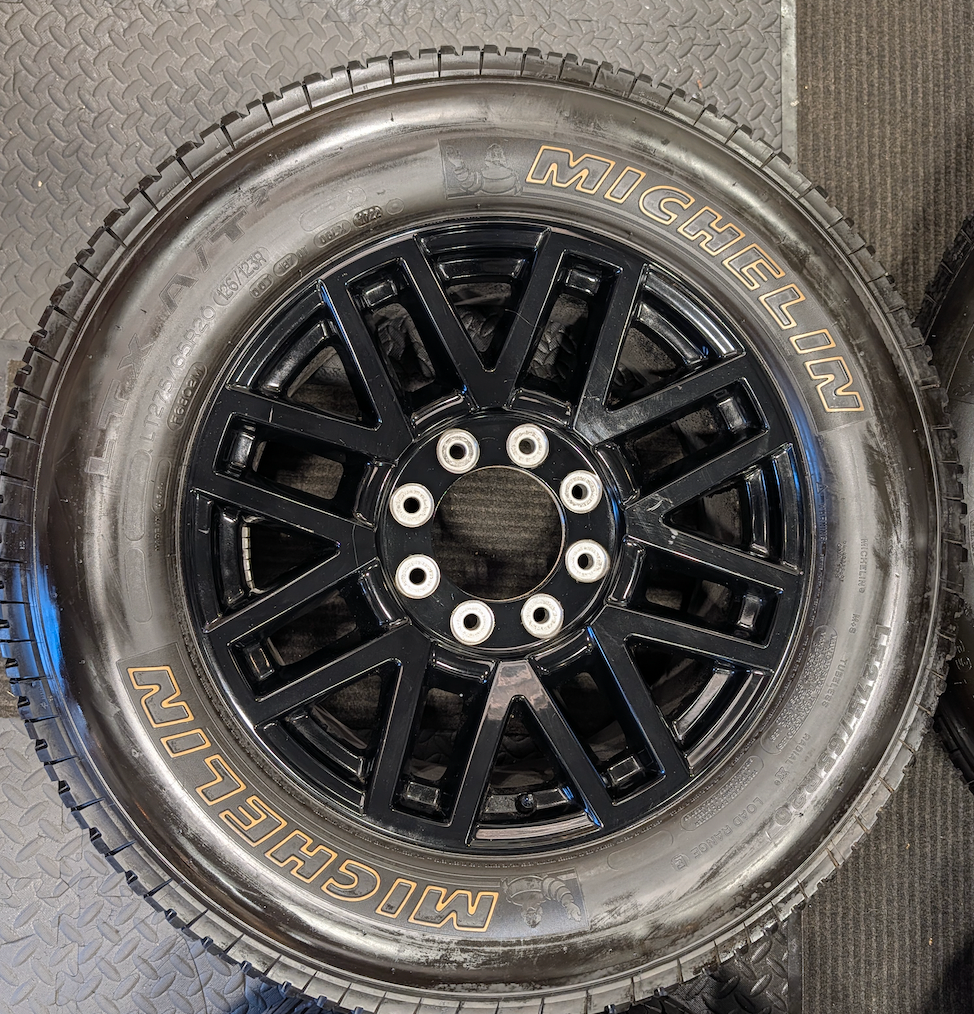 OEM 20” Gloss Black Ford F-250 / F-350 Wheels wrapped in Michelin LTX tires.