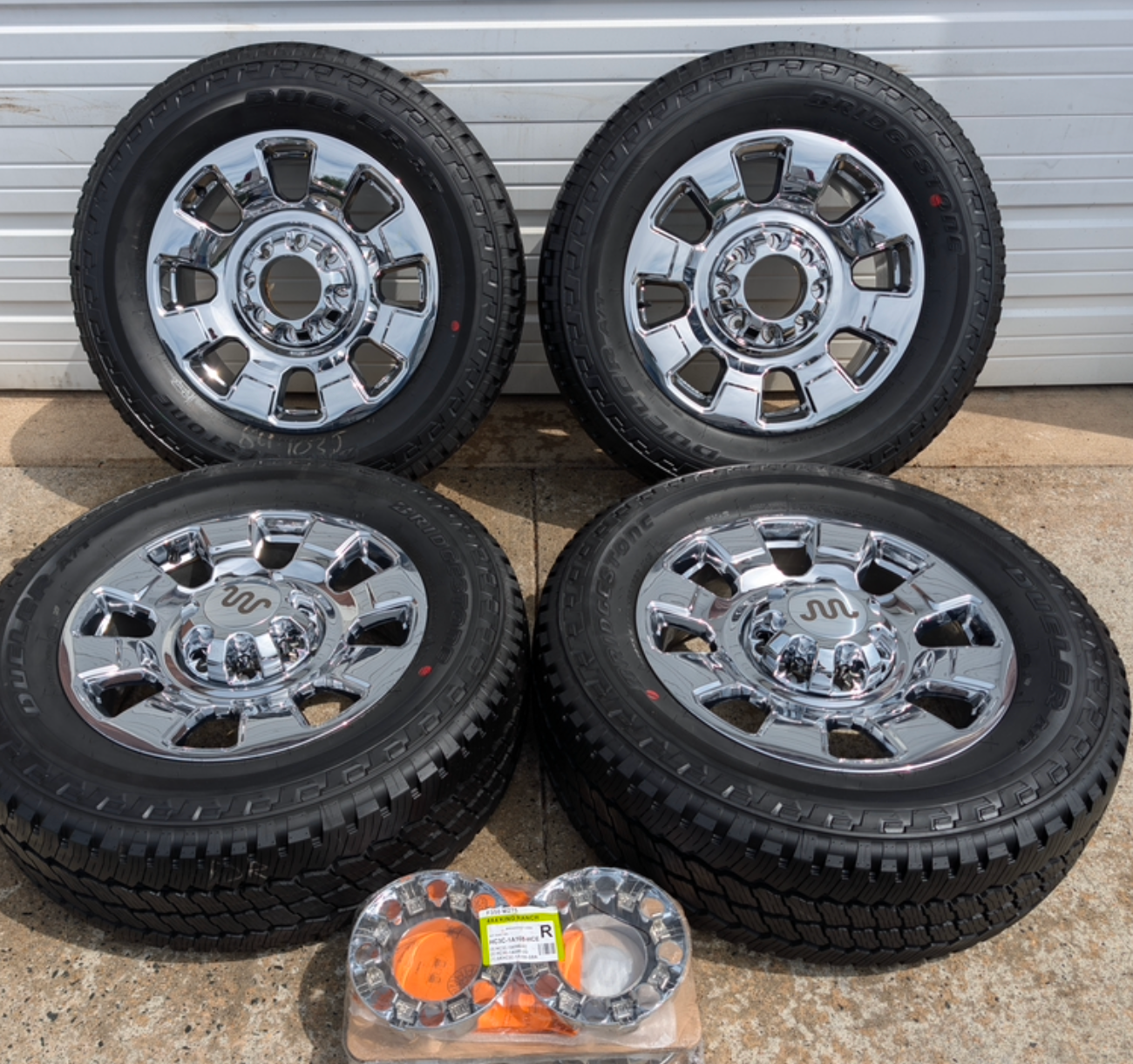 OEM 20” Chrome Ford F-250 / F-350 Wheels wrapped in Bridgestone Dueler A/T tires.