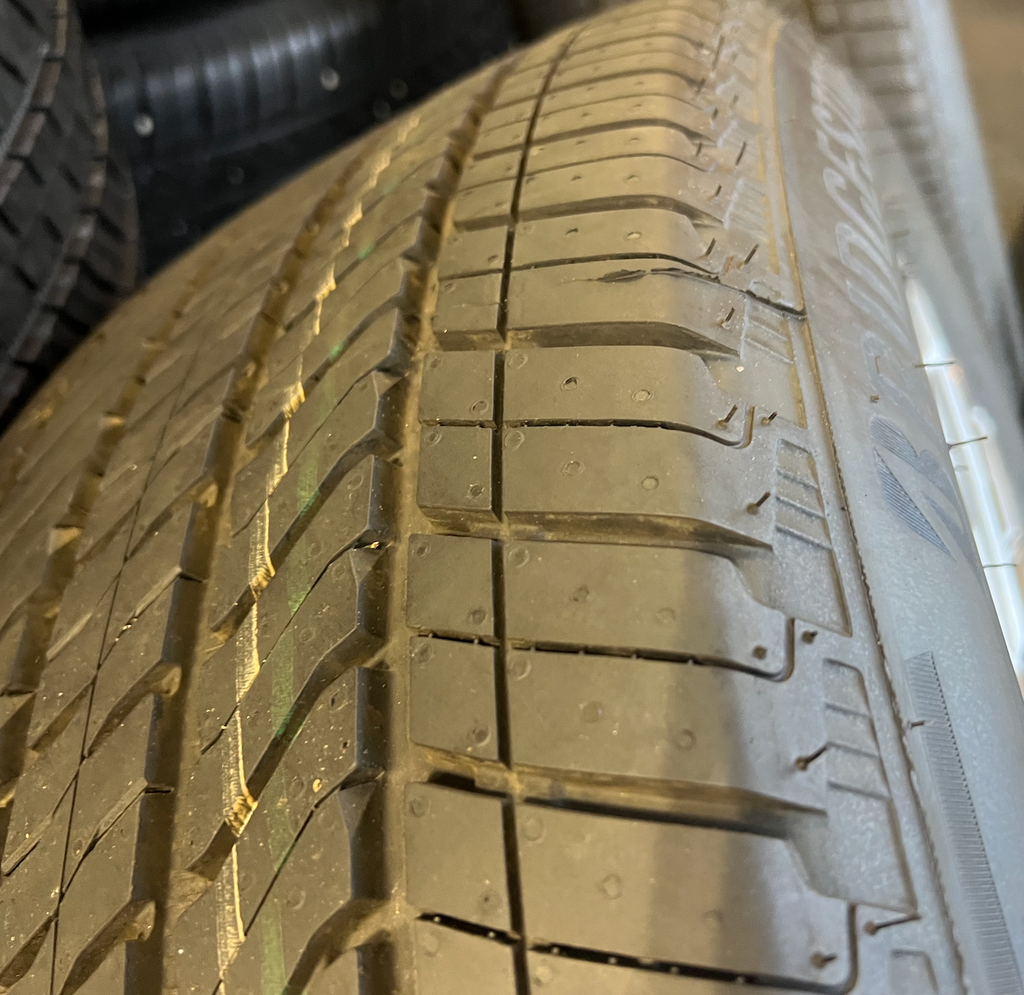 OEM 22” Machined Silver Denali Wheels wrapped in Bridgestone tires.