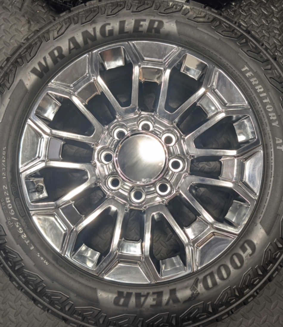 OEM 22” Chrome Chevrolet Silverado 2500HD / 3500HD & GMC Sierra 2500HD / 3500HD Wheels wrapped in Goodyear Wrangler Territory A/T tires.
