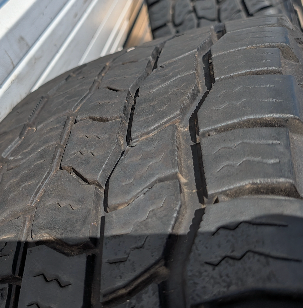 OEM 20” Machined Black GMC Sierra 2500HD / 3500HD Wheels wrapped in Cooper Discoverer AT3 tires.