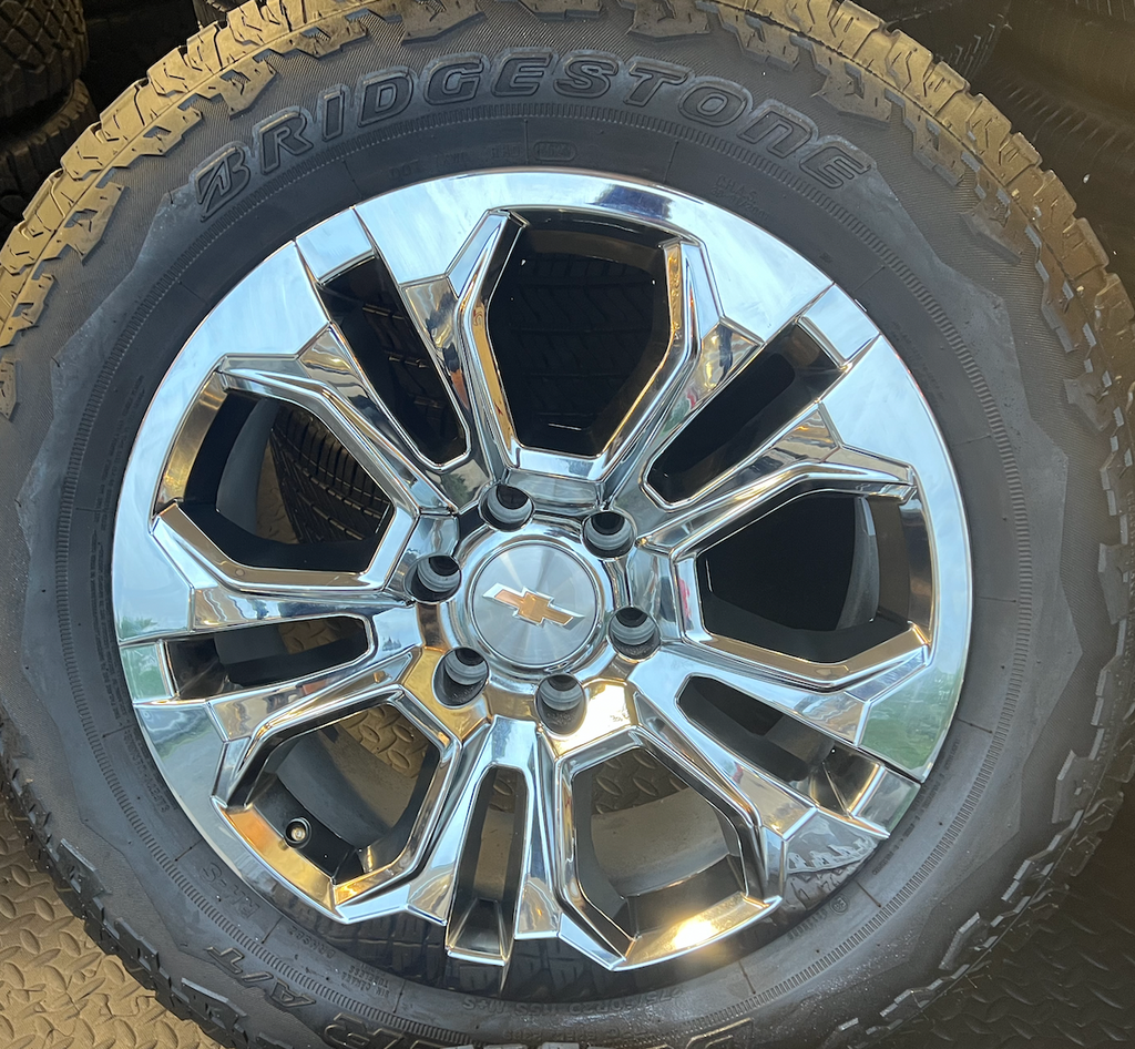 OEM 20” Chrome Wheels wrapped in Bridgestone Dueler tires.