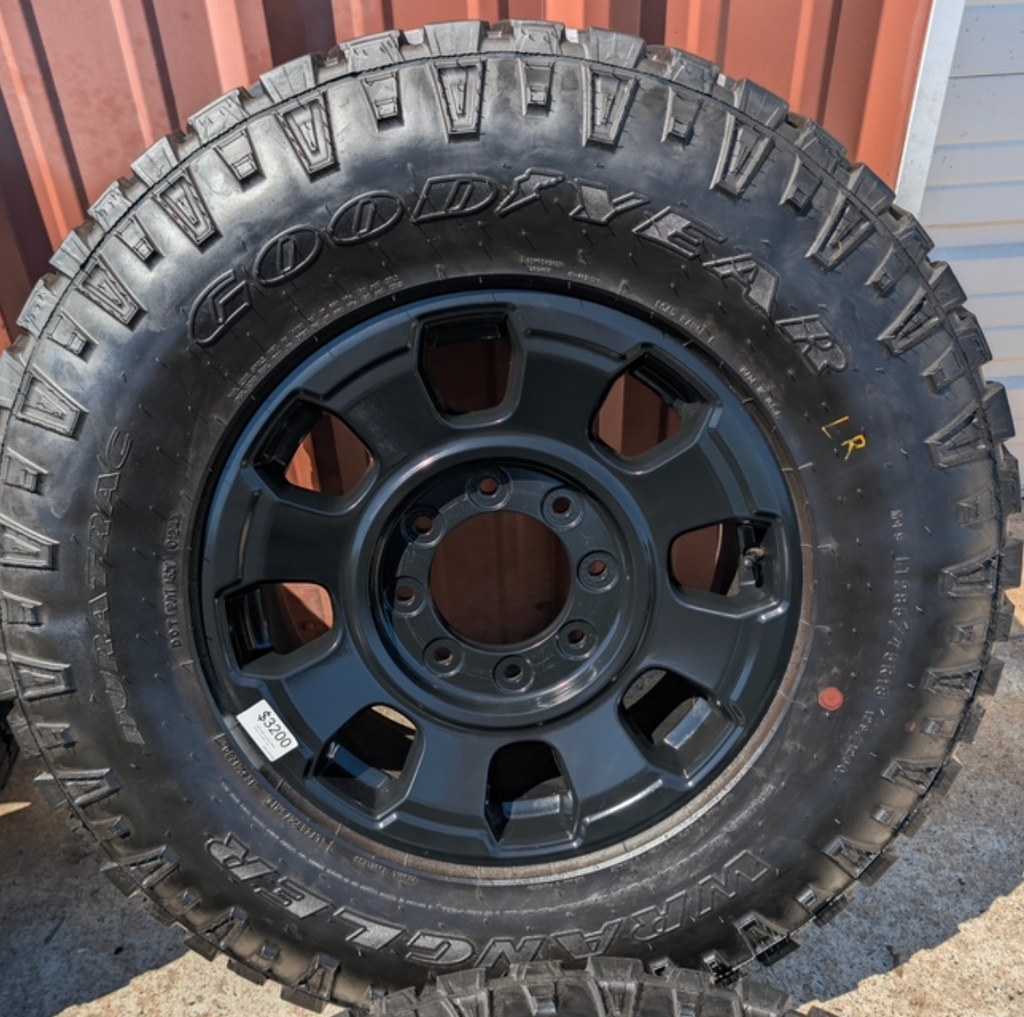 OEM 18” Ford F-250 / F-350 Tremor Wheels with Matte Black Finish wrapped in Goodyear Wrangler Duratrac tires.