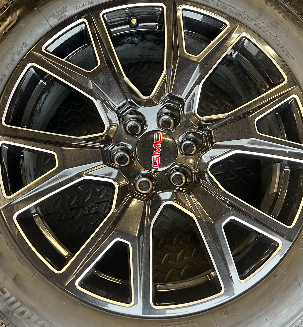 OEM 22” Gloss Black Machined Wheels wrapped in Bridgestone tires.