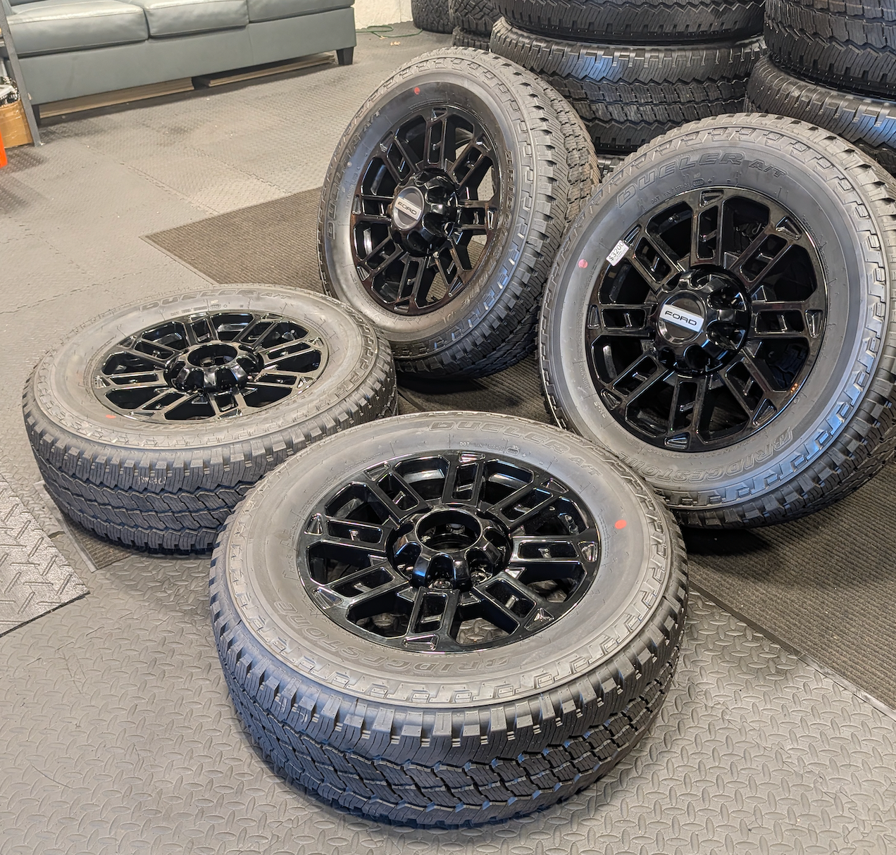 OEM 20” Gloss Black Ford F-250 / F-350 Wheels wrapped in Bridgestone Dueler A/T tires.