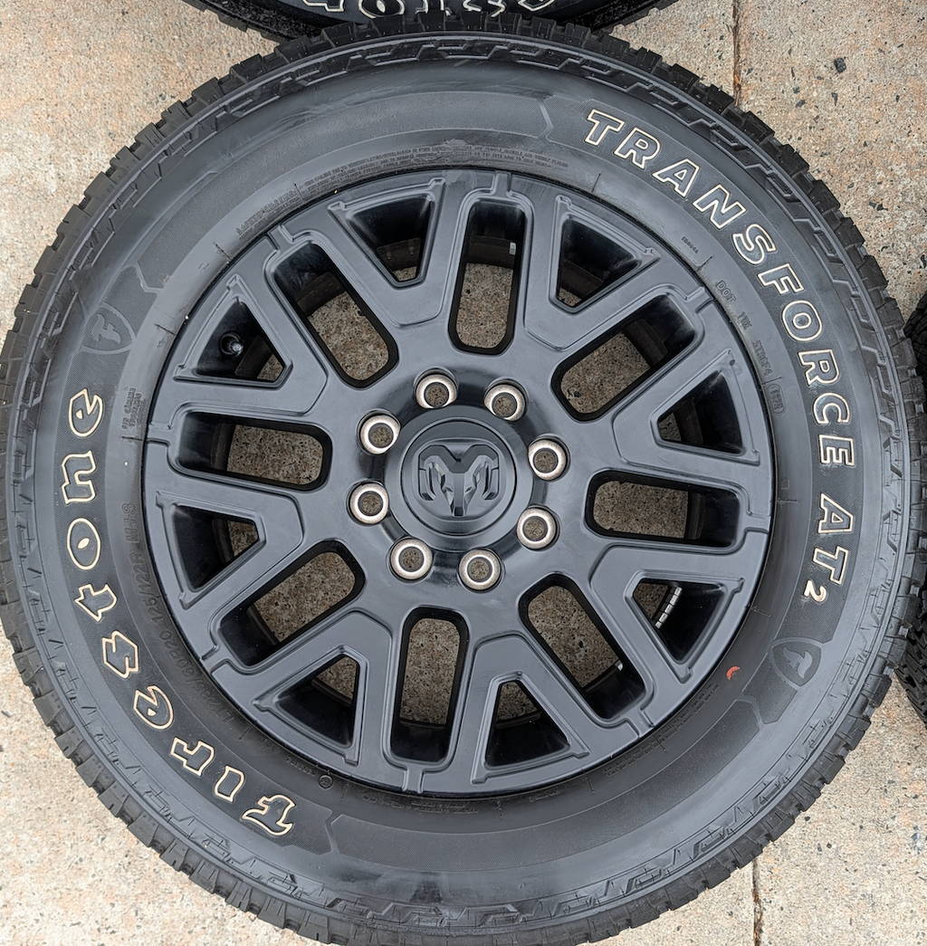 Matte Black Ram 2500 / 3500 OEM 20” Wrapped in Firestone Transforce AT2 LT285/60R20