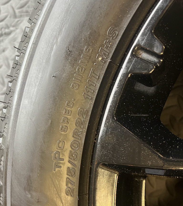 OEM 22” Gloss Black Replica Wheels wrapped in Bridgestone tires.