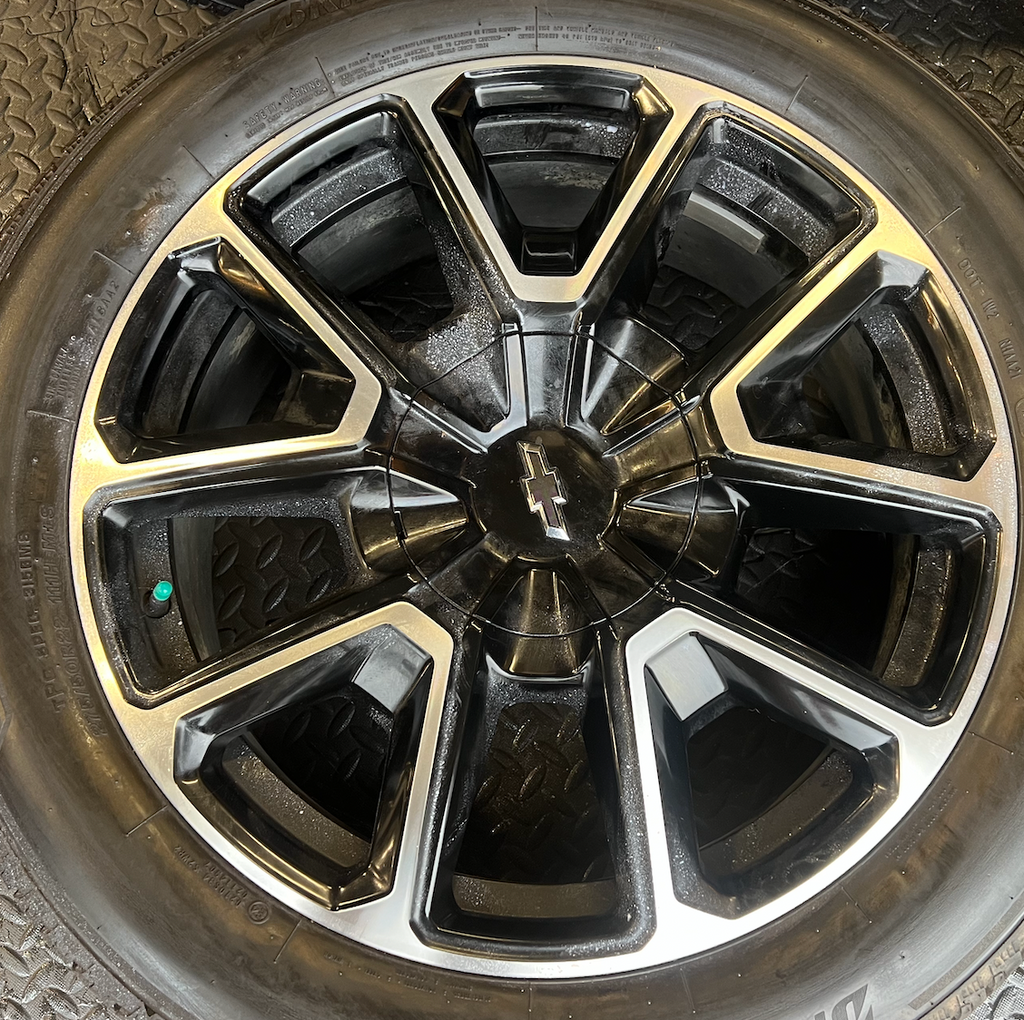 OEM 22” Black Machined Chevrolet Tahoe/Suburban Wheels wrapped in Bridgestone tires.