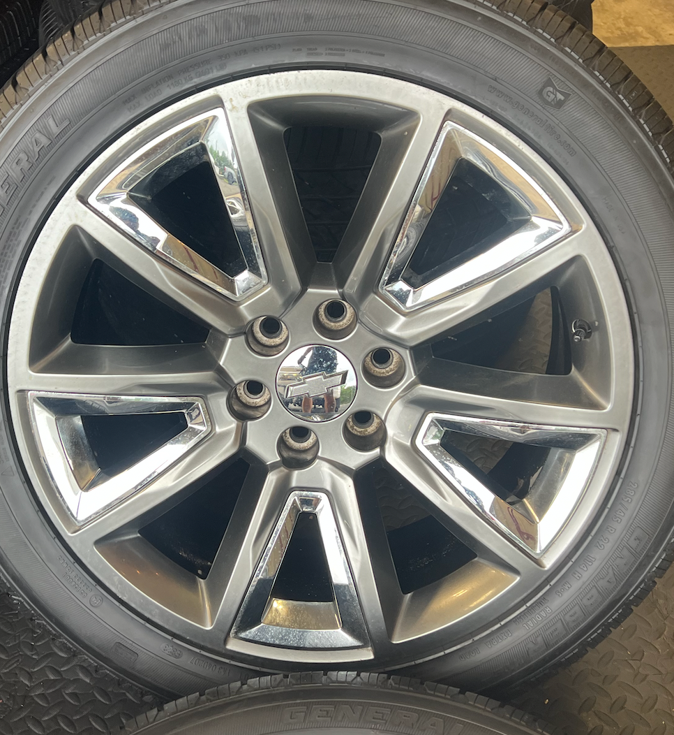 OEM 22” Wheels with Hypersilver Finish & Chrome Inserts wrapped in General Grabber tires.
