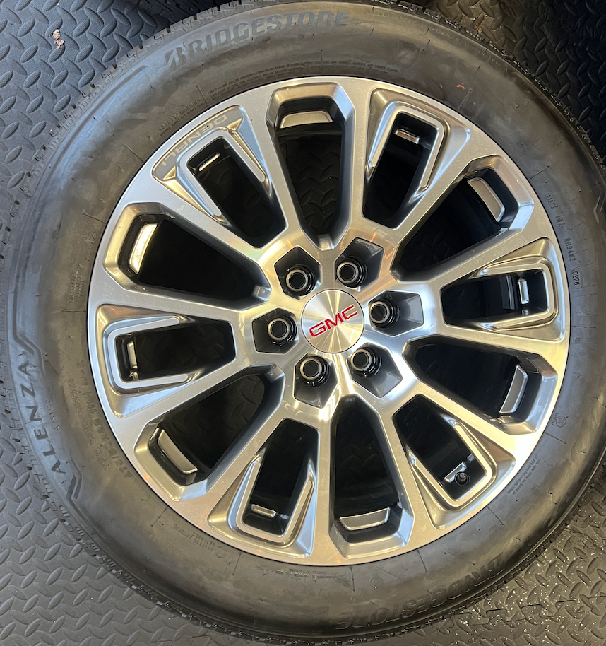 OEM 22” Machined Silver Denali Wheels wrapped in Bridgestone tires.