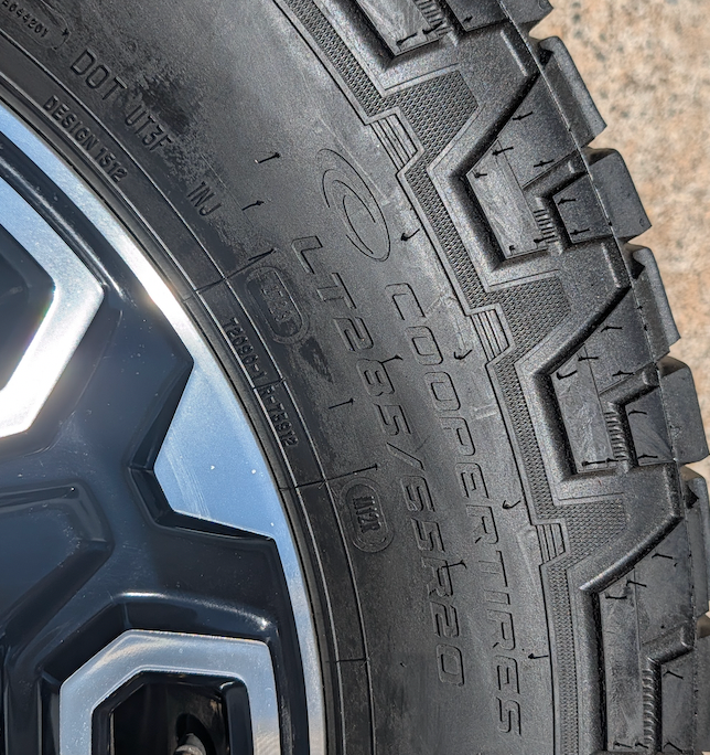 OEM 20” Machined Black GMC Sierra 2500HD / 3500HD Wheels wrapped in Cooper Discoverer AT3 tires.