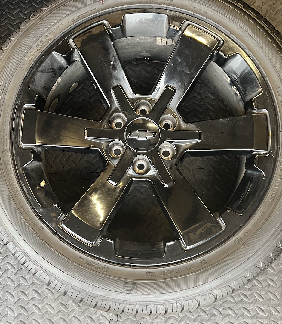 OEM 22” Gloss Black Wheels wrapped in General Grabber tires.