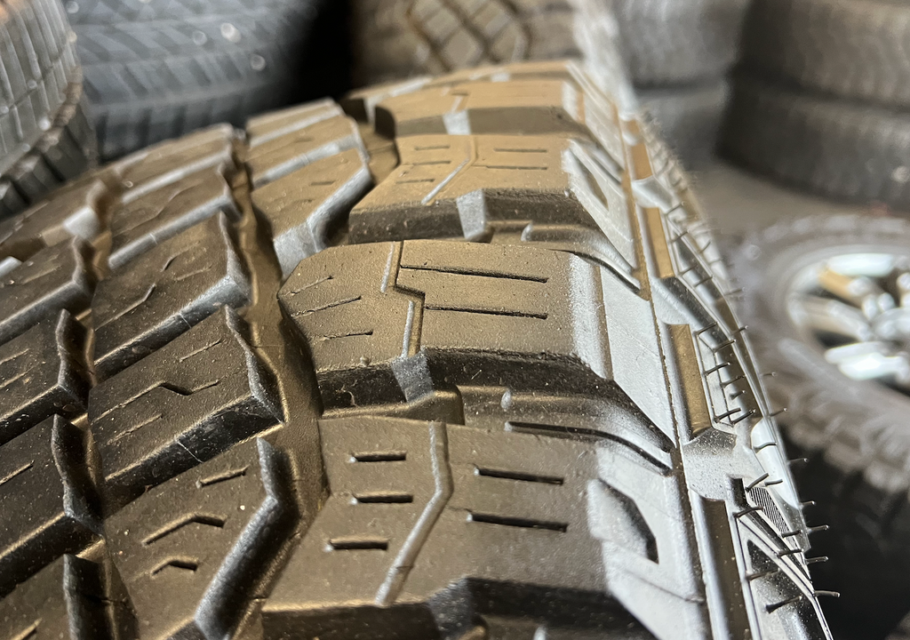 OEM 18" at4x machined aluminum Wheels wrapped in Goodyear tires.