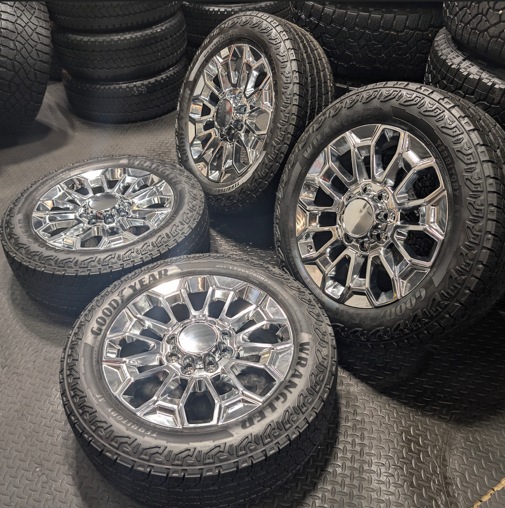OEM 22” Chrome Chevrolet Silverado 2500HD / 3500HD & GMC Sierra 2500HD / 3500HD Wheels wrapped in Goodyear Wrangler Territory A/T tires.