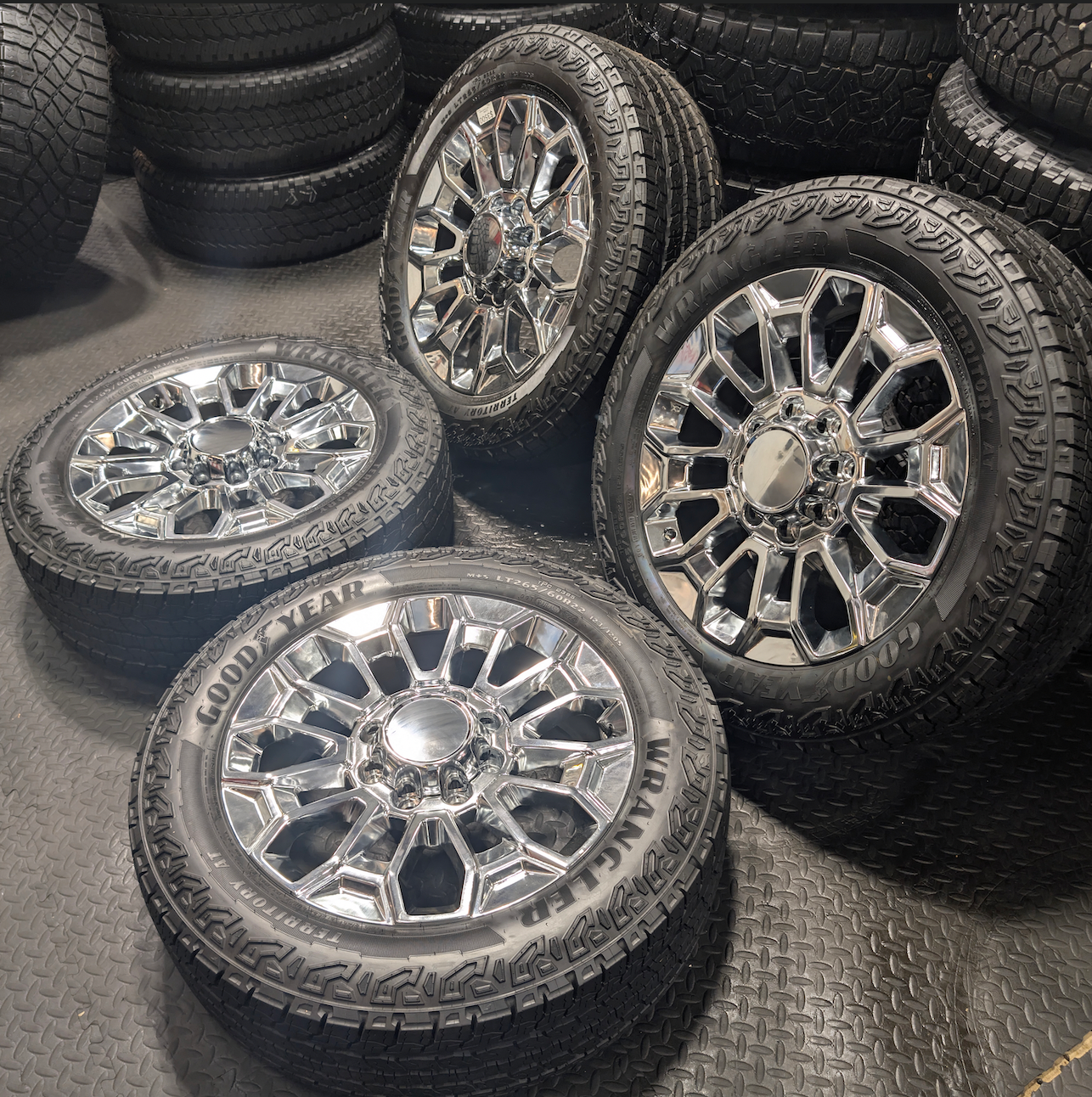 OEM 22” Chrome Chevrolet Silverado 2500HD / 3500HD & GMC Sierra 2500HD / 3500HD Wheels wrapped in Goodyear Wrangler Territory A/T tires.