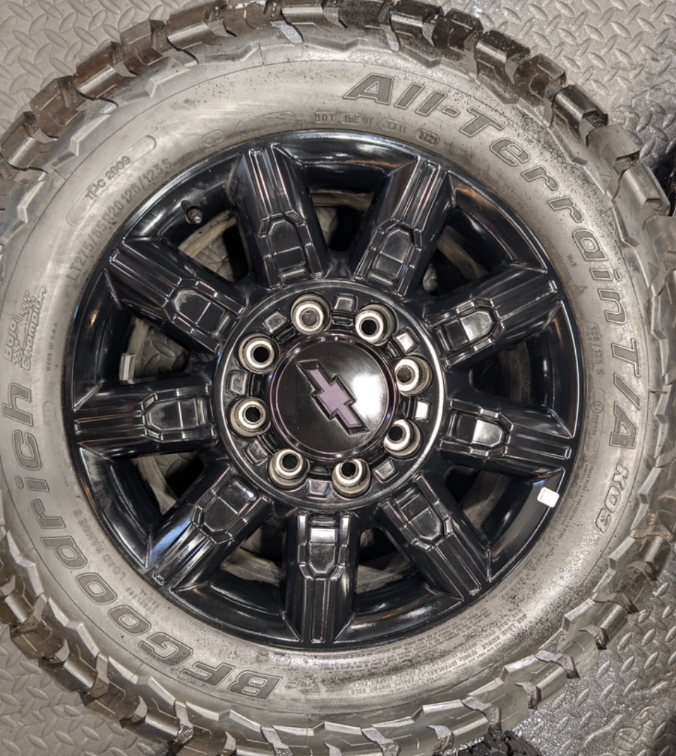 OEM 20” Gloss Black Chevrolet Silverado 2500HD / 3500HD Wheels wrapped in BFGoodrich All-Terrain T/A KO3 tires.