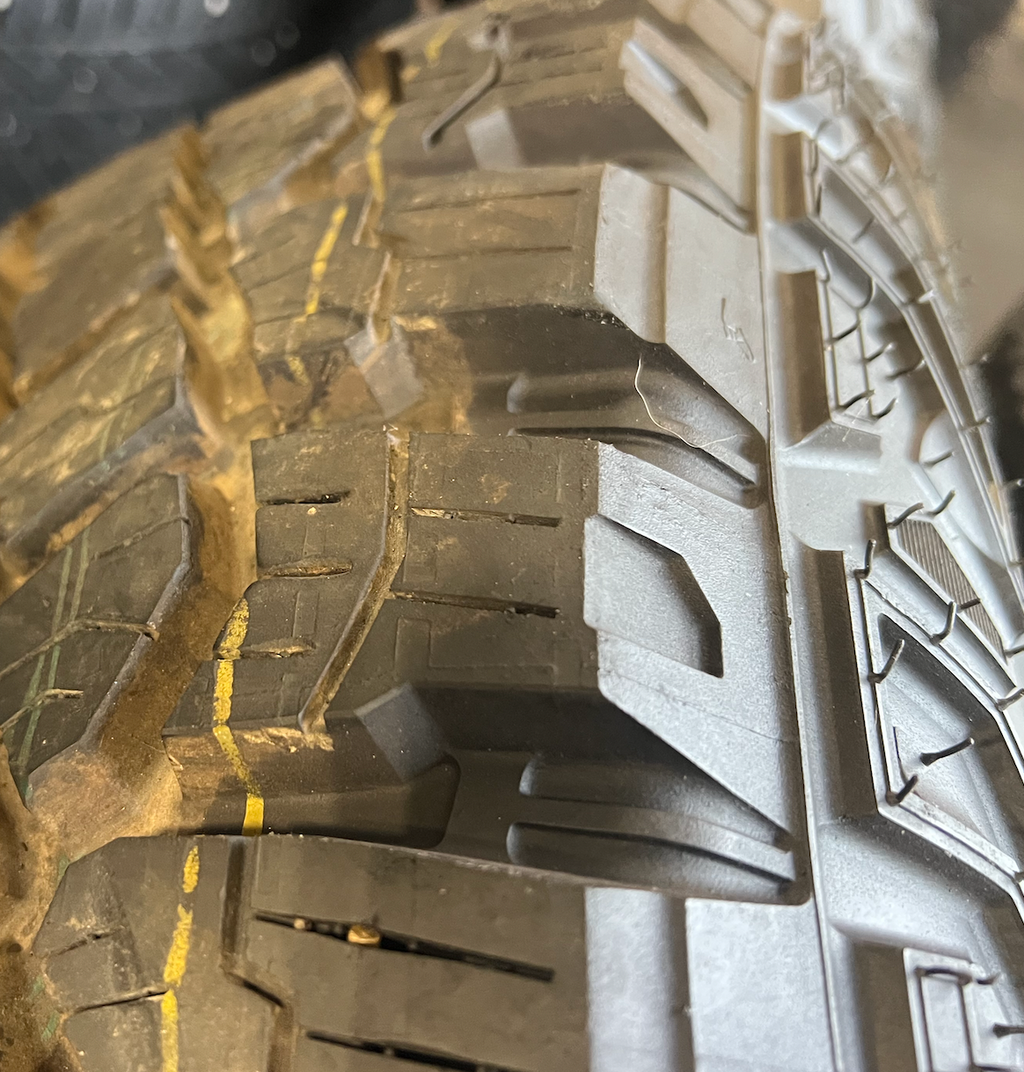 OEM 18” Gloss Black Machined Face Chevrolet Wheels wrapped in Goodyear Wrangler Territory M/T tires.