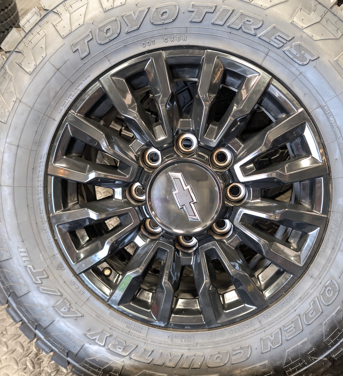 OEM 18” Chevrolet Silverado ZR2 2500HD / 3500HD Gloss Black Wheels wrapped in Toyo Open Country A/T tires.