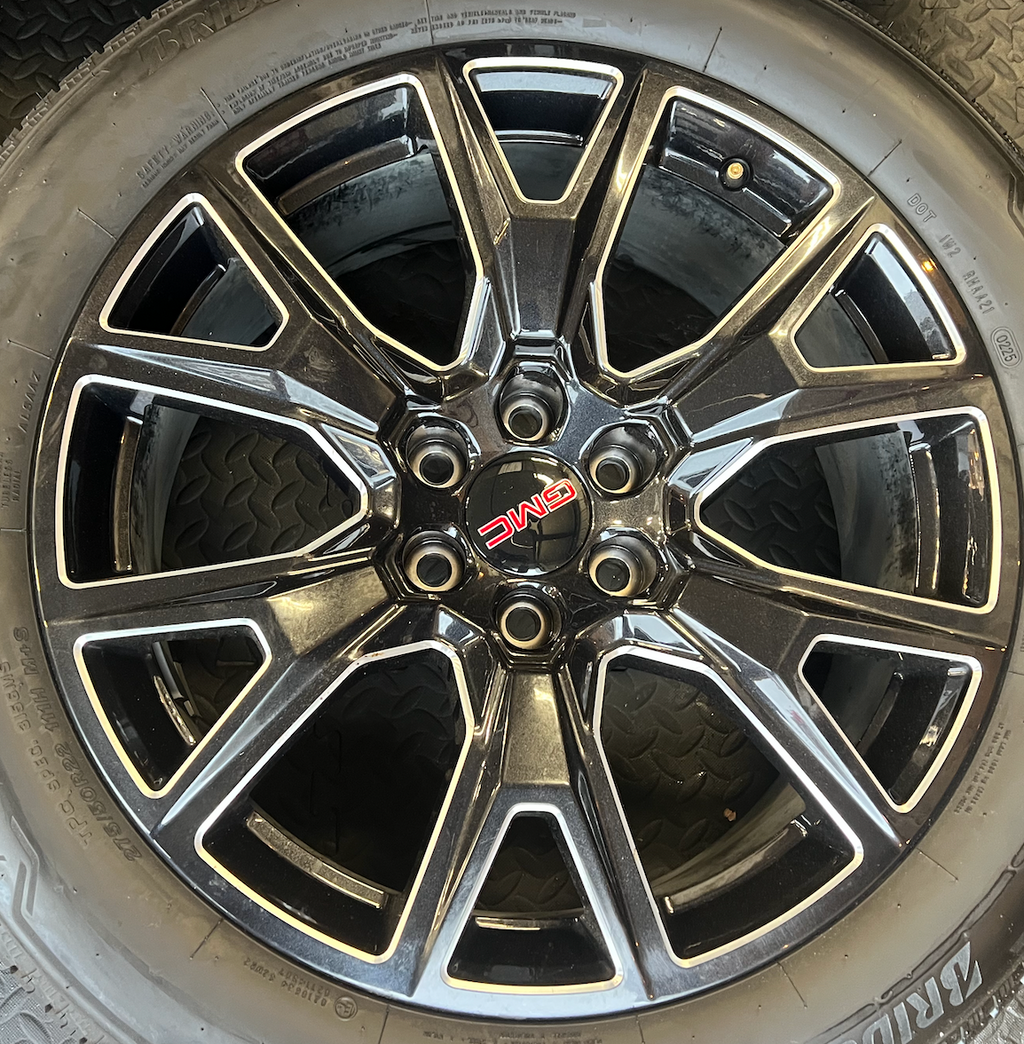 OEM 22” Gloss Black Machined Wheels wrapped in Bridgestone tires.