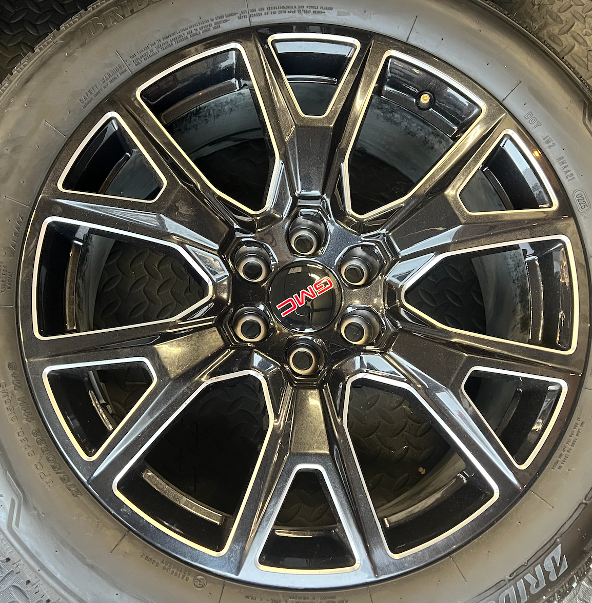 OEM 22” Gloss Black Machined Wheels wrapped in Bridgestone tires.