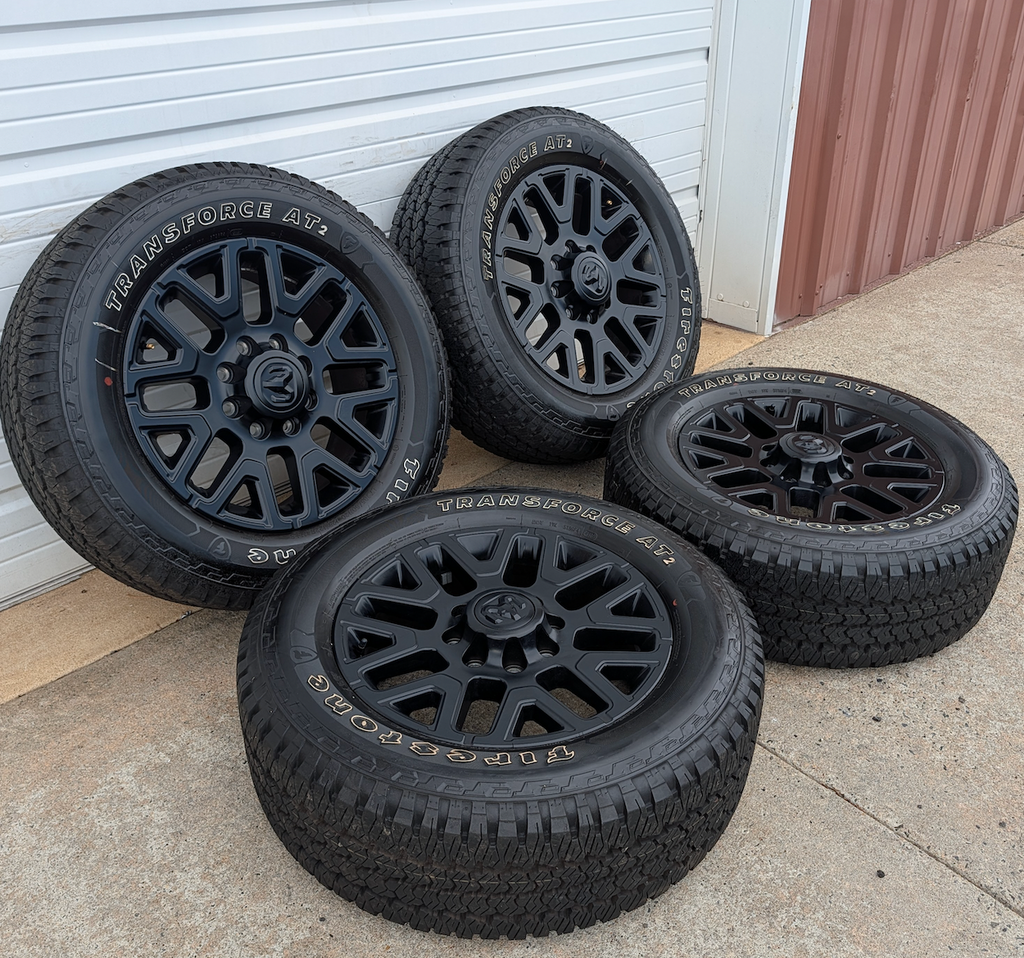 Matte Black Ram 2500 / 3500 OEM 20” Wrapped in Firestone Transforce AT2 LT285/60R20