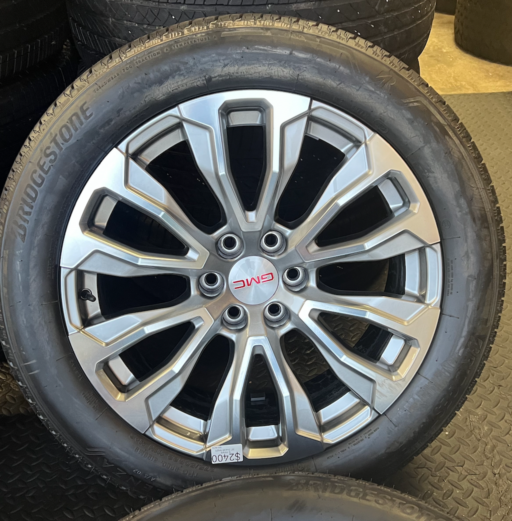 OEM 22” Denali Wheels with Machined & Grey Finish wrapped in Bridgestone tires.
