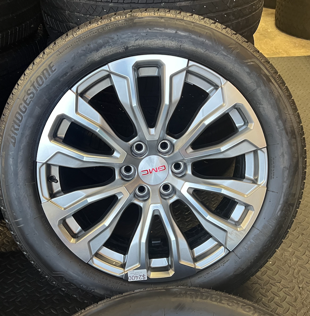 OEM 22” Denali Wheels with Machined & Grey Finish wrapped in Bridgestone tires.