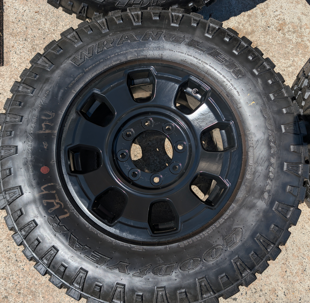 OEM 18” Ford F-250 / F-350 Tremor Wheels with Matte Black Finish wrapped in Goodyear Wrangler Duratrac tires.