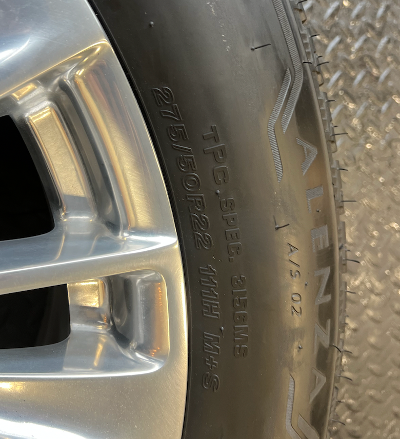 OEM 22” Polished Aluminum Wheels wrapped in Bridgestone tires.