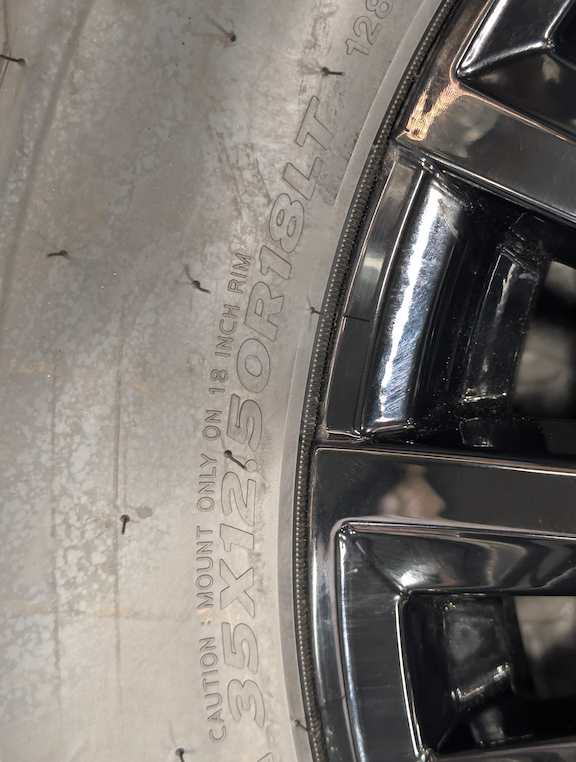 OEM 18” Gloss Black GMC Sierra / Chevrolet Silverado 2500HD & 3500HD Wheels wrapped in Hankook Dynapro XT tires.