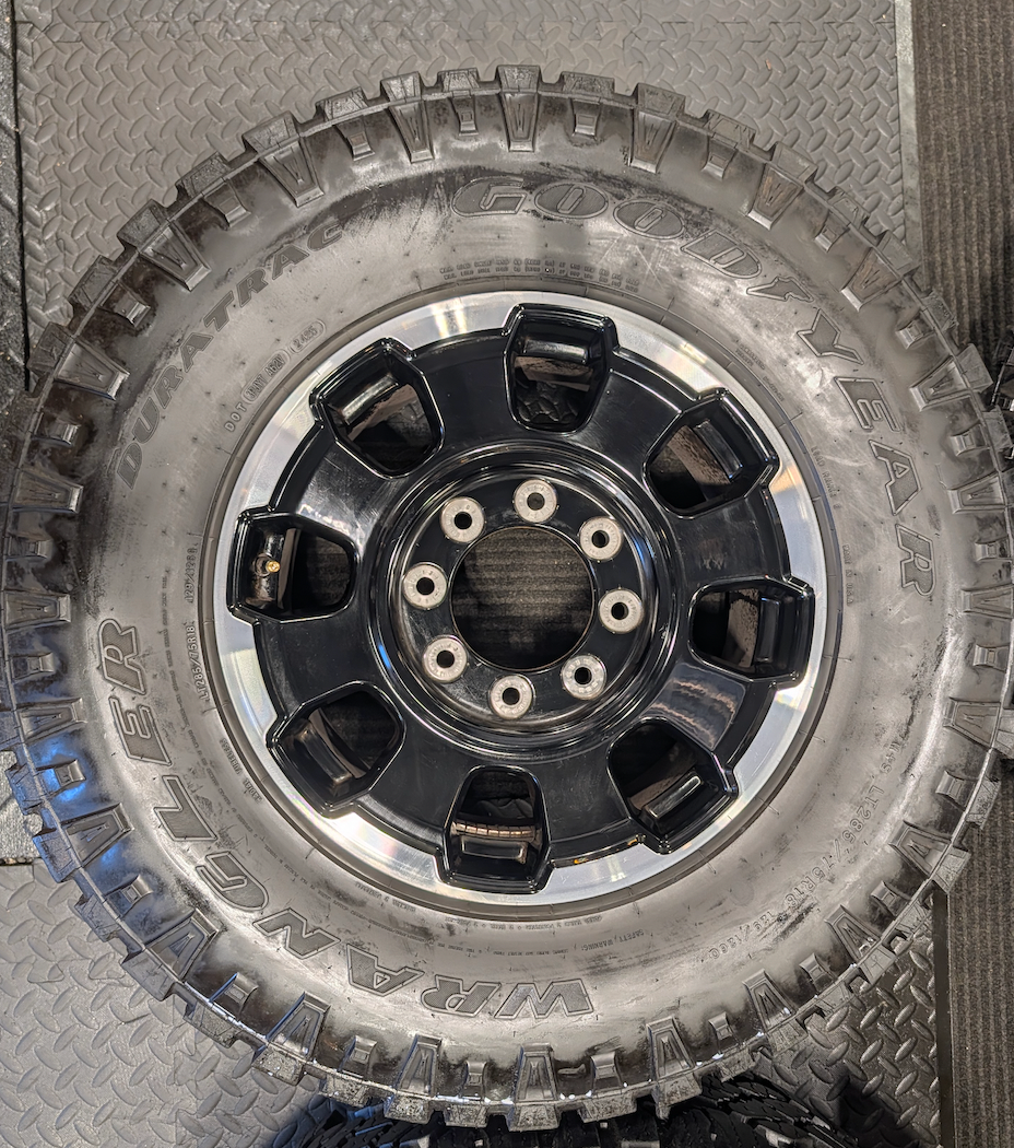 OEM 18” Gloss Black Machined Ford F-250 / F-350 Tremor Wheels wrapped in LT285/75R18 Goodyear Wrangler DuraTrac tires.