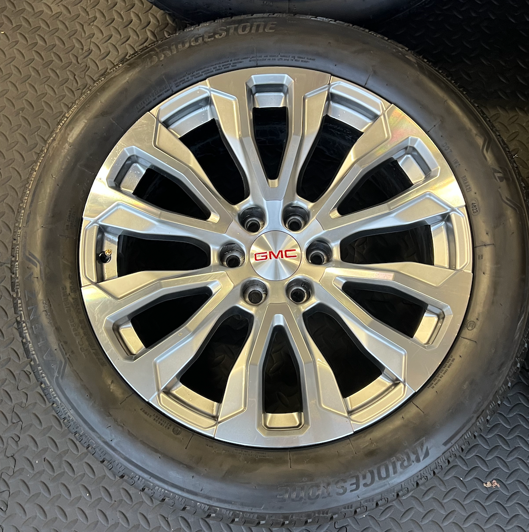 OEM 22” Denali Wheels with Machined & Grey Finish wrapped in Bridgestone tires.