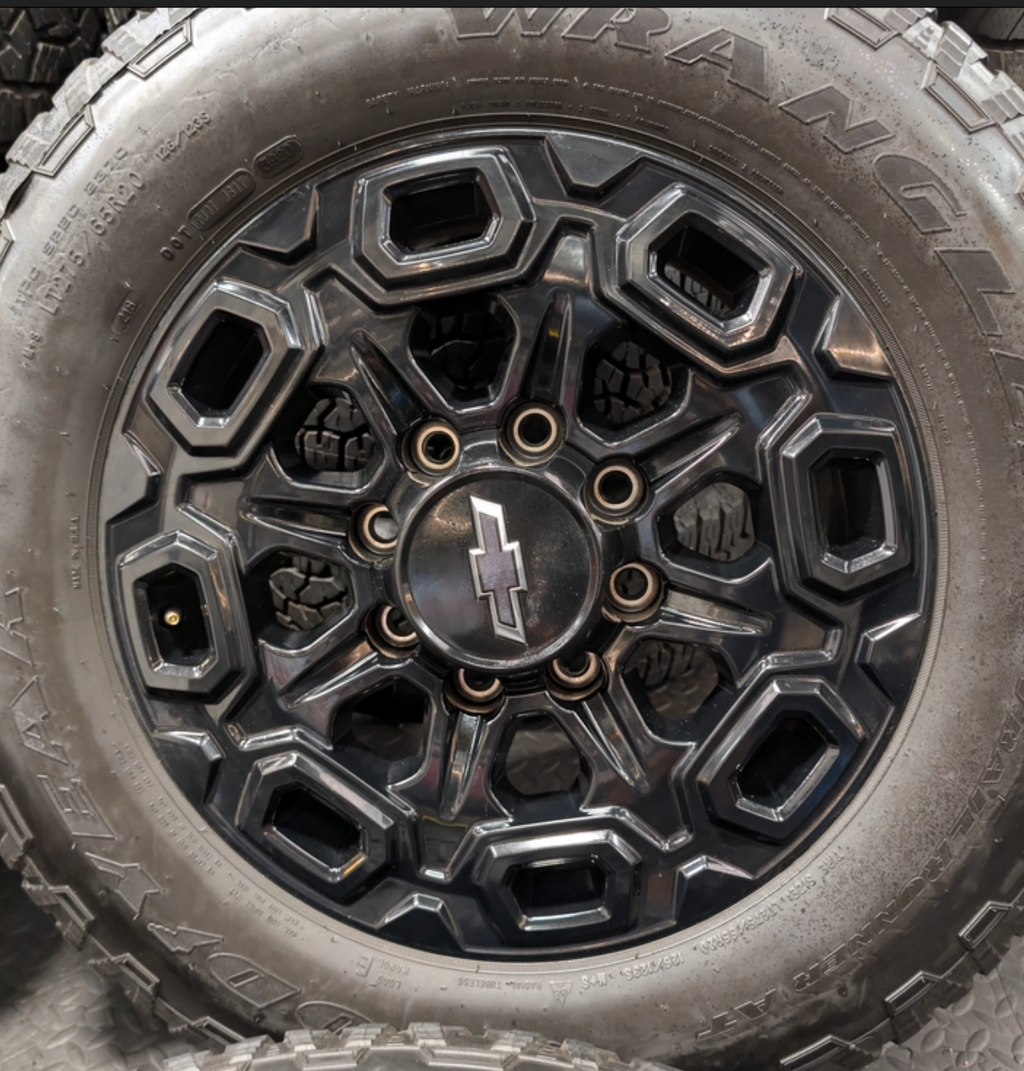 OEM 20” Gloss Black Chevrolet Silverado / GMC Sierra 2500HD & 3500HD Wheels wrapped in LT275/65R20 Goodyear Wrangler TrailRunner A/T tires.