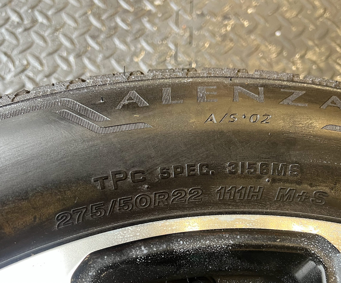 OEM 22” Black Machined Chevrolet Tahoe/Suburban Wheels wrapped in Bridgestone tires.