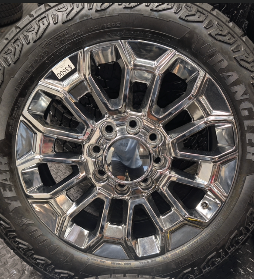 OEM 22” Chrome Chevrolet Silverado 2500HD / 3500HD & GMC Sierra 2500HD / 3500HD Wheels wrapped in Goodyear Wrangler Territory A/T tires.