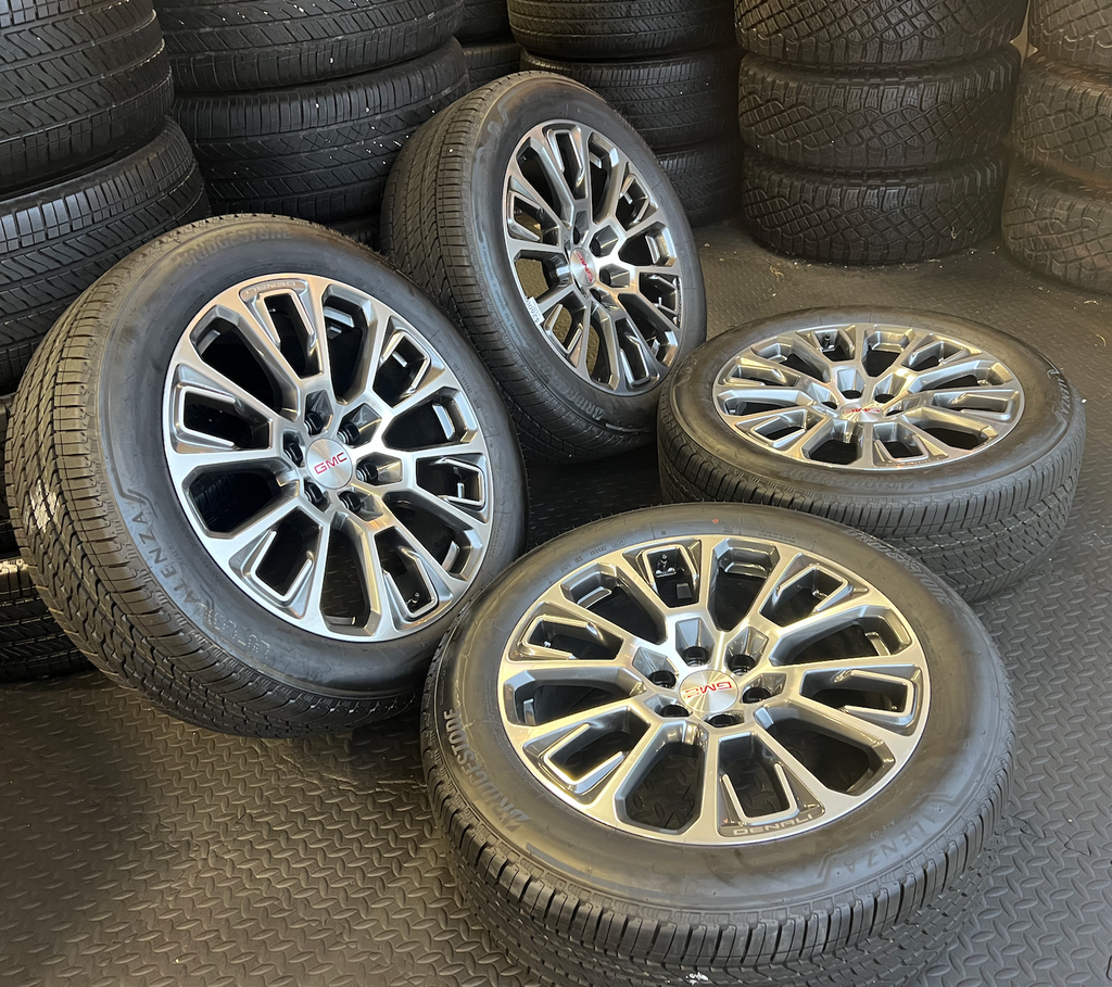 OEM 22” Machined Silver Denali Wheels wrapped in Bridgestone tires.