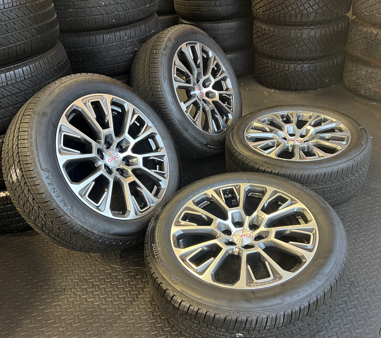 OEM 22” Machined Silver Denali Wheels wrapped in Bridgestone tires.