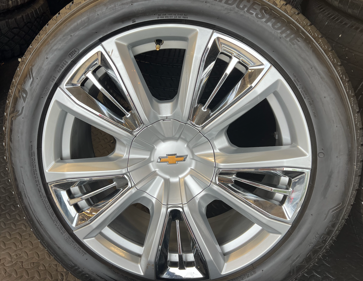 OEM 22” Chevrolet High Country Wheels wrapped in Bridgestone tires.