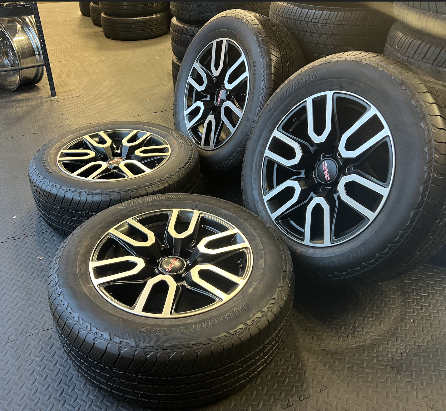 OEM 20” Gloss Black Wheels with Silver Inserts / Accents wrapped in Hankook Dynapro AT2 tires.