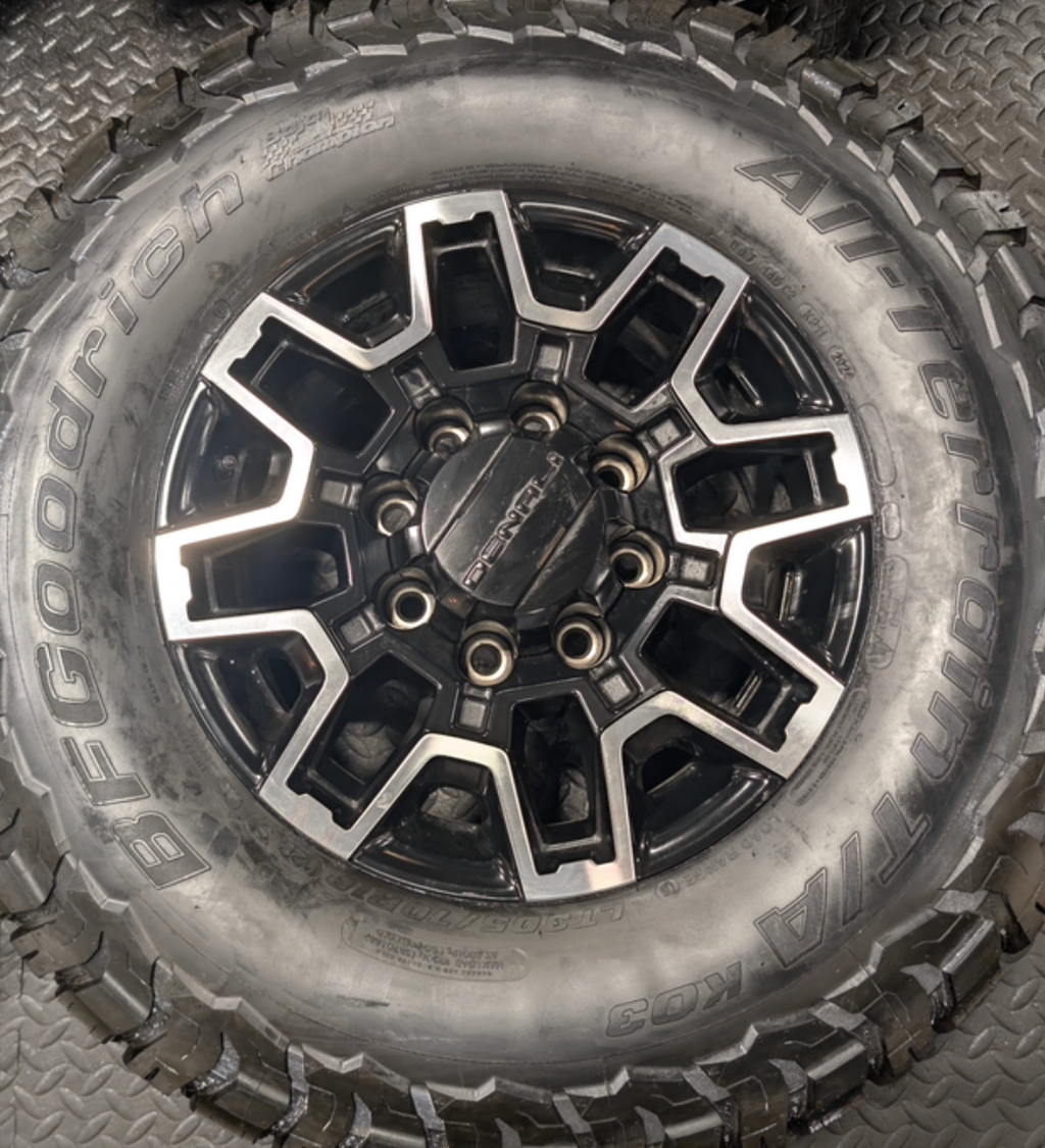 OEM 18” GMC Sierra 2500HD Wheels with Machined Black Finish wrapped in LT305/70R18 BFGoodrich All-Terrain T/A KO3 tires.