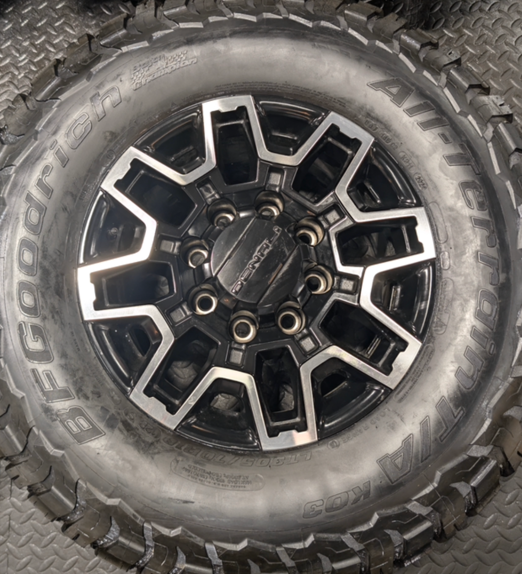 OEM 18” GMC Sierra 2500HD Wheels with Machined Black Finish wrapped in LT305/70R18 BFGoodrich All-Terrain T/A KO3 tires.