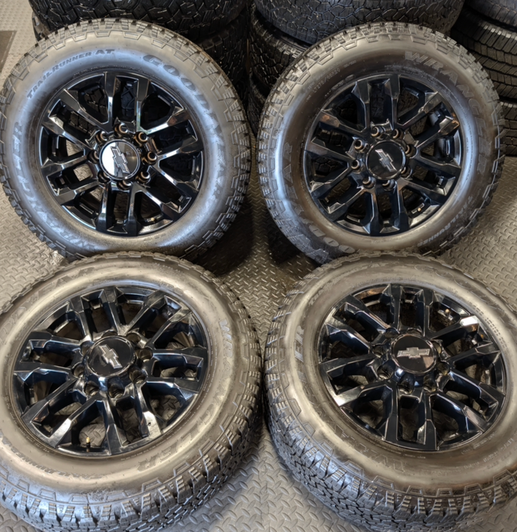 OEM 20” Gloss Black Chevrolet Silverado / GMC Sierra 2500HD & 3500HD Wheels wrapped in LT275/65R20 Goodyear Wrangler TrailRunner A/T tires.