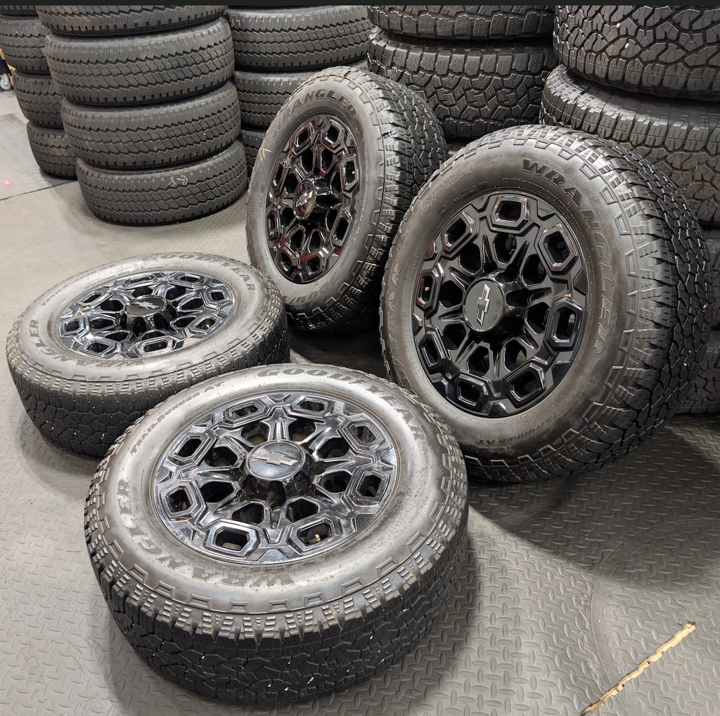 OEM 20” Gloss Black Chevrolet Silverado / GMC Sierra 2500HD & 3500HD Wheels wrapped in LT275/65R20 Goodyear Wrangler TrailRunner A/T tires.